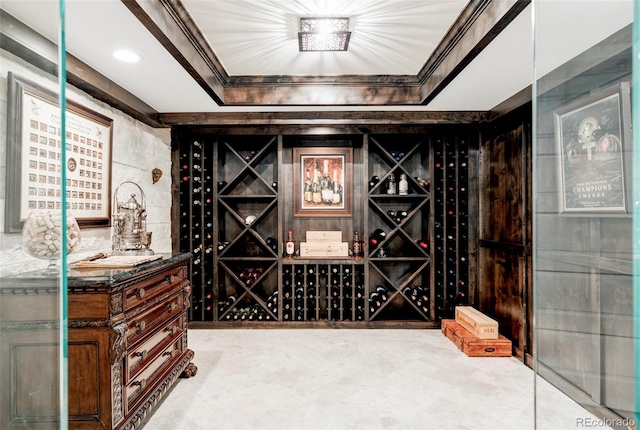 wine area featuring crown molding and a tray ceiling