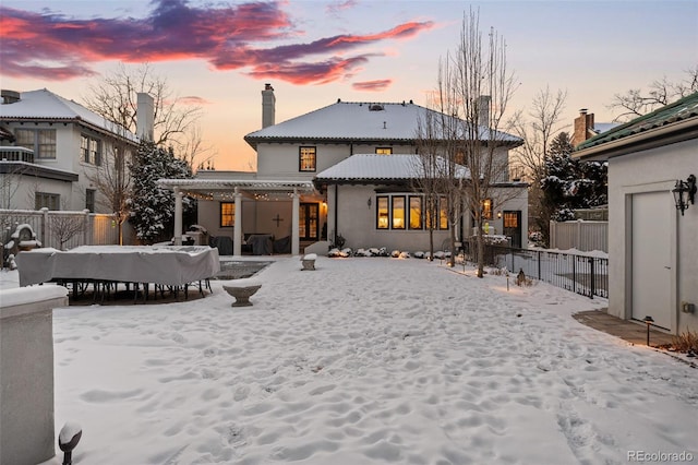 view of snow covered rear of property