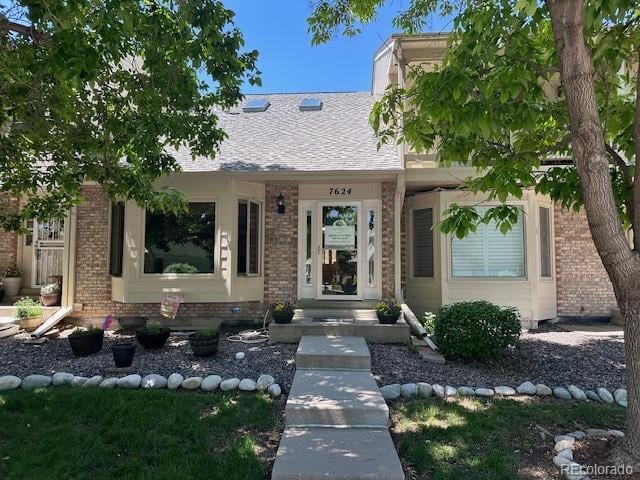 7624 S Cove Cir, Centennial, CO 80122 - view of front facade featuring brick siding and a shingled roof