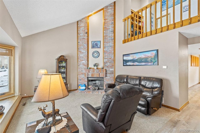 7624 S Cove Cir, Centennial, CO 80122 - carpeted living area with high vaulted ceiling and a fireplace