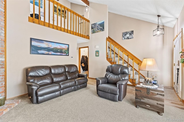 7624 S Cove Cir, Centennial, CO 80122 - living area featuring carpet floors, high vaulted ceiling, and stairway