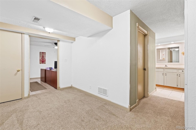 7624 S Cove Cir, Centennial, CO 80122 - basement with light carpet, a textured ceiling, and a ceiling fan