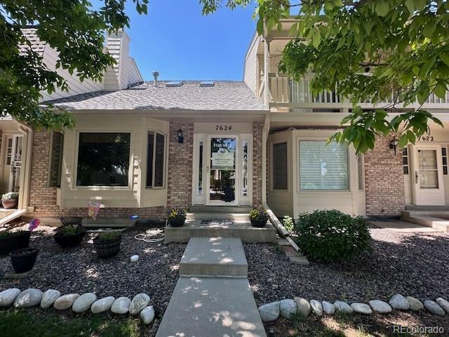 7624 S Cove Cir, Centennial, CO 80122 - view of front facade with brick siding and a chimney