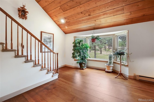 688 Obsidian Dr, Florissant, CO 80816 - entryway featuring vaulted ceiling, hardwood / wood-style flooring, stairs, wood ceiling, and a baseboard radiator