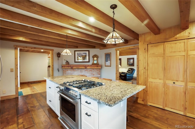 688 Obsidian Dr, Florissant, CO 80816 - kitchen featuring gas range, beam ceiling, dark wood-type flooring, white cabinets, and light stone countertops