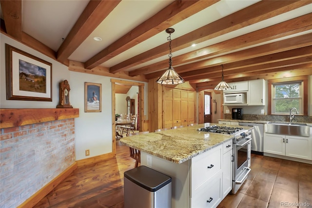 688 Obsidian Dr, Florissant, CO 80816 - kitchen with stainless steel stove, dishwashing machine, a sink, white microwave, and white cabinetry