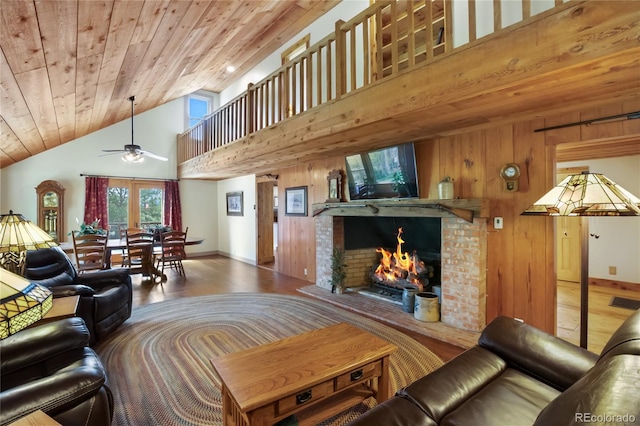 688 Obsidian Dr, Florissant, CO 80816 - living room featuring wood finished floors, a ceiling fan, wooden ceiling, a brick fireplace, and wooden walls