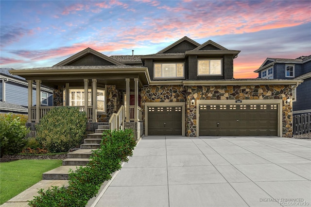 view of front of house featuring driveway and stone siding