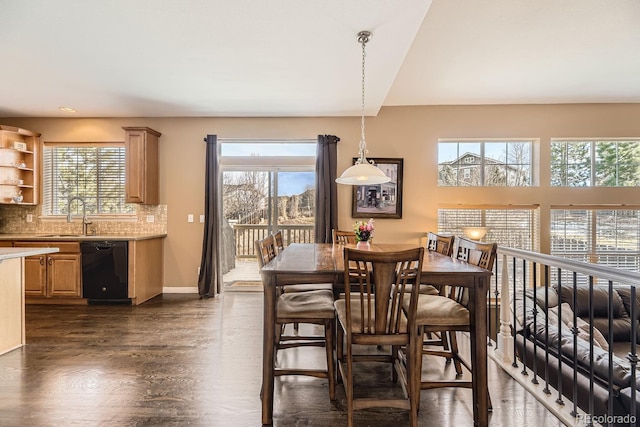 dining space with dark wood-style flooring, plenty of natural light, and baseboards