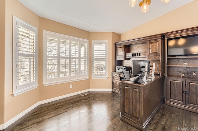 office area featuring dark wood-type flooring, visible vents, vaulted ceiling, and baseboards