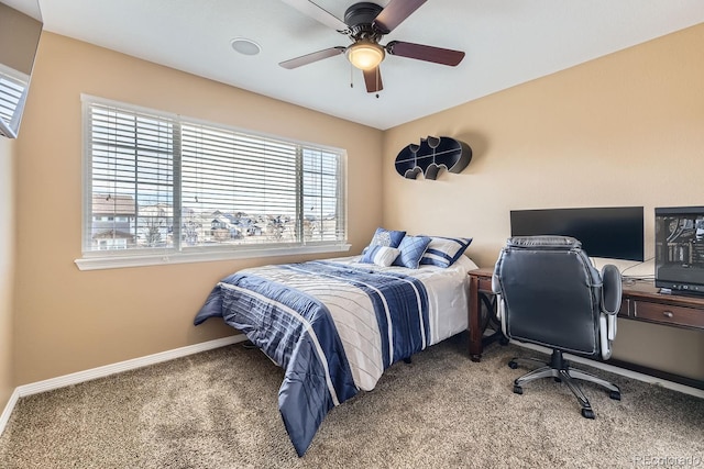 bedroom with a ceiling fan, baseboards, and carpet flooring