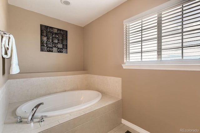 full bathroom with tile patterned flooring, a garden tub, and baseboards