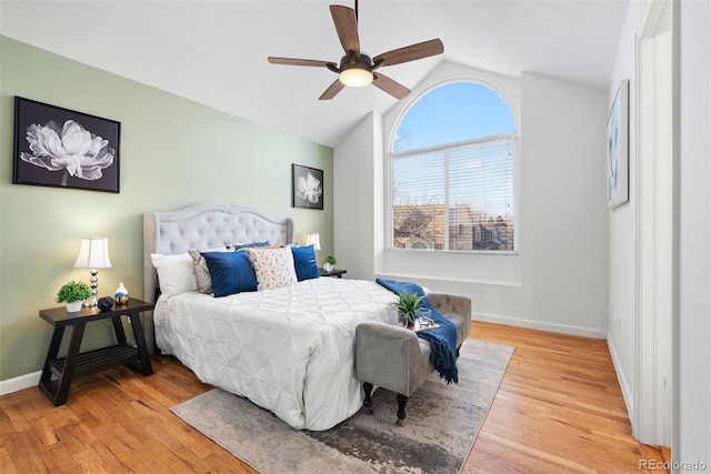 bedroom featuring ceiling fan, hardwood / wood-style flooring, and lofted ceiling