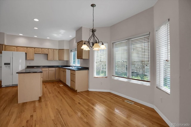 kitchen with white appliances, plenty of natural light, a chandelier, baseboards, and recessed lighting