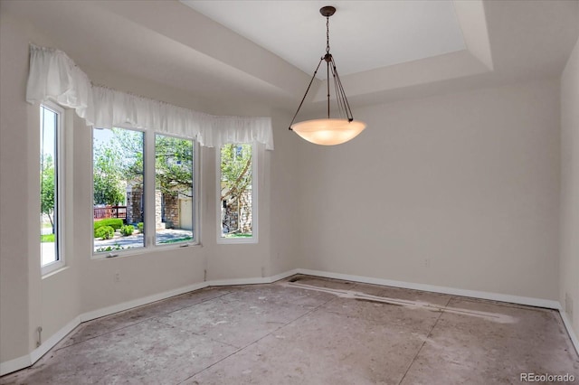 unfurnished dining area featuring healthy amount of natural light and baseboards