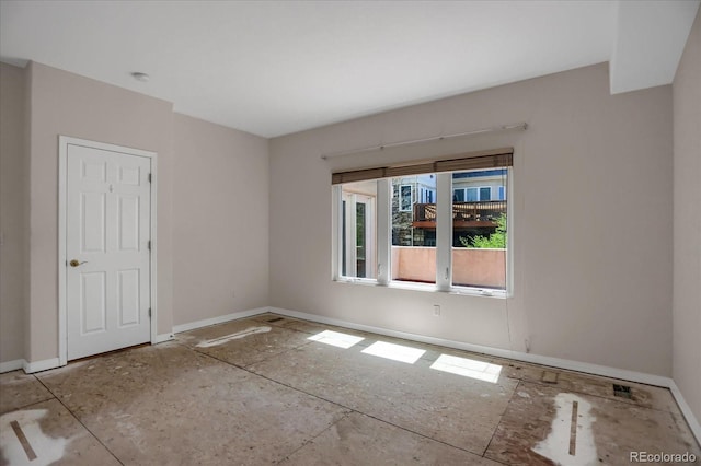 unfurnished room featuring baseboards