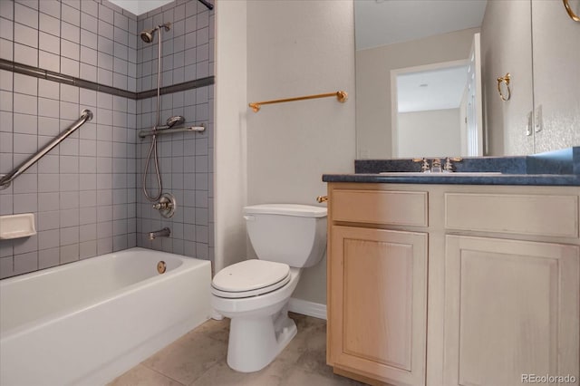 bathroom with toilet, bathtub / shower combination, vanity, tile patterned floors, and baseboards