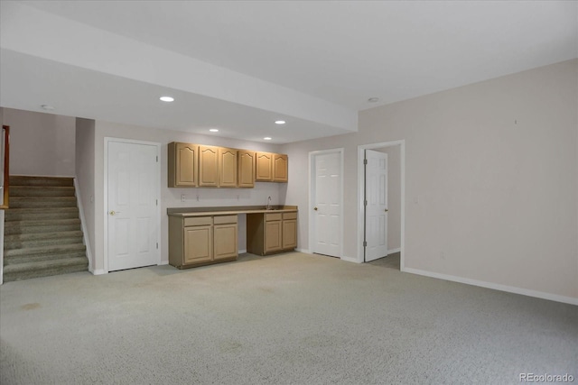 kitchen with light carpet, baseboards, recessed lighting, light countertops, and light brown cabinets