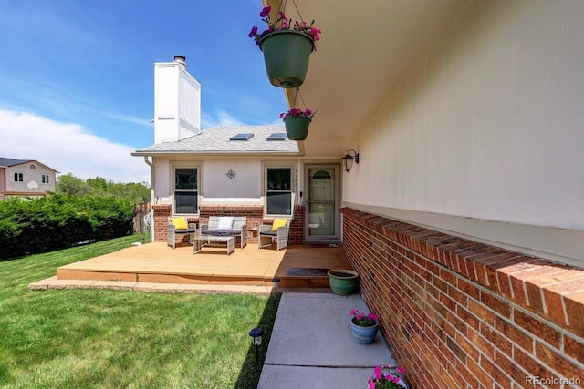 rear view of house featuring brick siding, a wooden deck, a yard, a chimney, and an outdoor hangout area