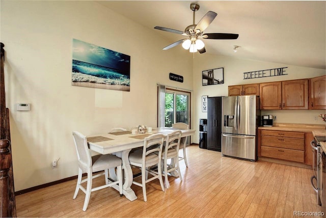 dining area featuring light wood finished floors, ceiling fan, and high vaulted ceiling