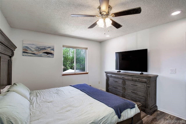 bedroom featuring a textured ceiling, dark wood-style flooring, a ceiling fan, recessed lighting, and baseboards