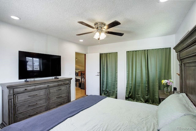 bedroom featuring recessed lighting, a textured ceiling, ceiling fan, and two closets