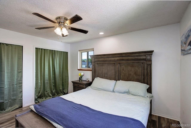 bedroom featuring wood finished floors, a textured ceiling, baseboards, ceiling fan, and recessed lighting