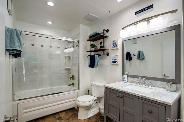 bathroom featuring toilet, enclosed tub / shower combo, vanity, and recessed lighting
