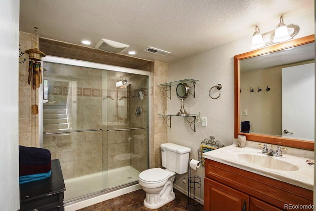 bathroom featuring toilet, a shower stall, vanity, a textured ceiling, and recessed lighting