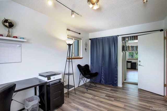 office space with wood finished floors and a textured ceiling