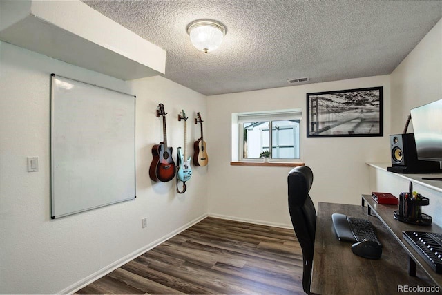 office space featuring a textured ceiling, wood finished floors, and baseboards
