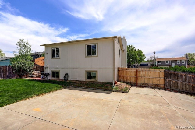 back of property featuring a patio area and a chimney