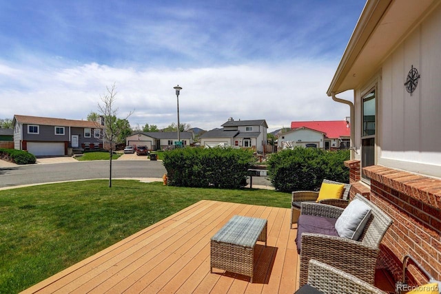 wooden terrace featuring a residential view and a yard