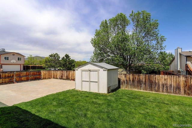 view of yard featuring a storage unit, a patio area, and an outdoor structure