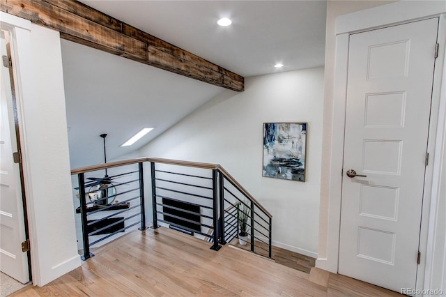 stairway featuring lofted ceiling with beams, baseboards, wood finished floors, and recessed lighting