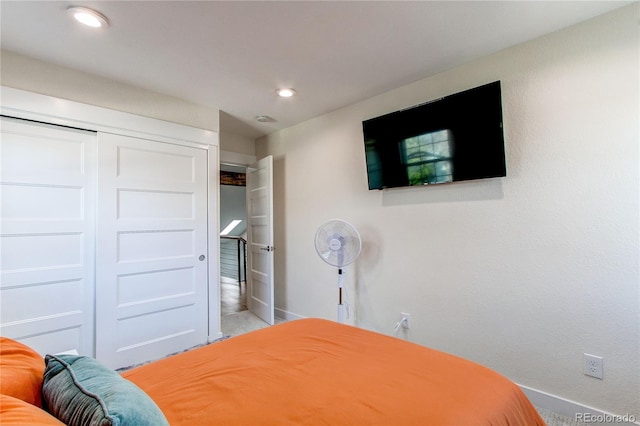 bedroom with a closet, recessed lighting, and baseboards