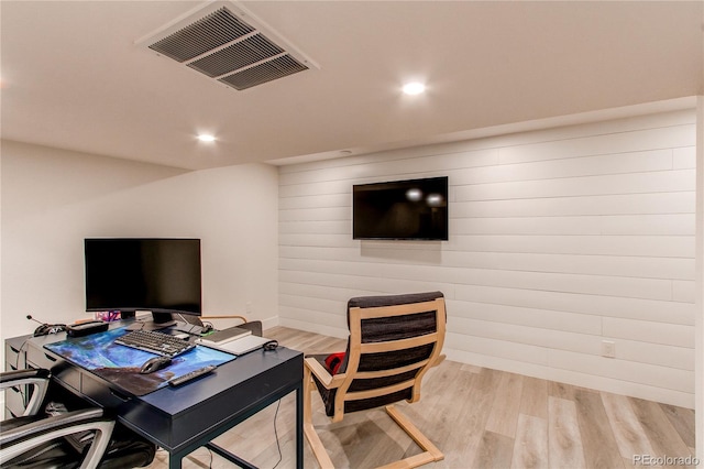 office featuring recessed lighting, visible vents, wood walls, and light wood finished floors