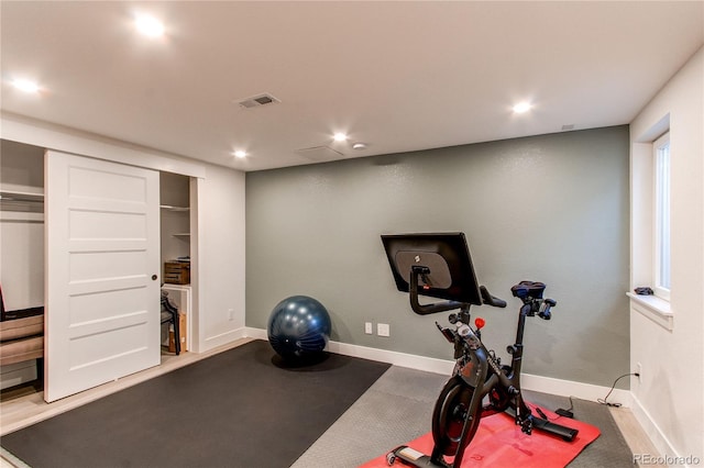 exercise area with recessed lighting, visible vents, and baseboards