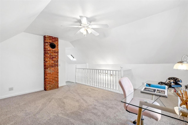 office area featuring baseboards, ceiling fan, carpet, and vaulted ceiling