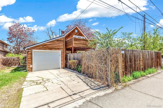 view of front of property with fence, a chimney, and concrete driveway