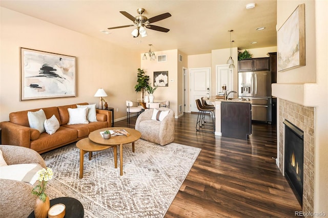 5562 W 72nd Pl, Westminster, CO 80003 - living room featuring dark wood finished floors, ceiling fan, and a tile fireplace