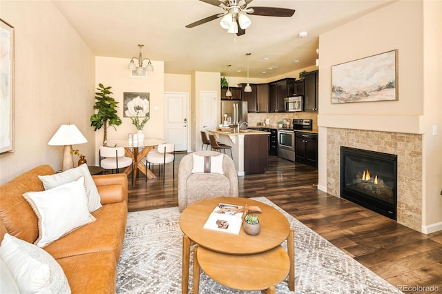 5562 W 72nd Pl, Westminster, CO 80003 - living area featuring dark wood finished floors, a ceiling fan, and a chandelier