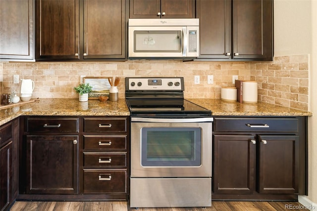 5562 W 72nd Pl, Westminster, CO 80003 - kitchen featuring stainless steel electric stove, dark brown cabinetry, tasteful backsplash, and light stone counters