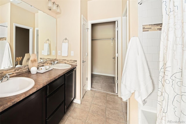 5562 W 72nd Pl, Westminster, CO 80003 - bathroom featuring double vanity, shower / bathtub combination with curtain, and a spacious closet