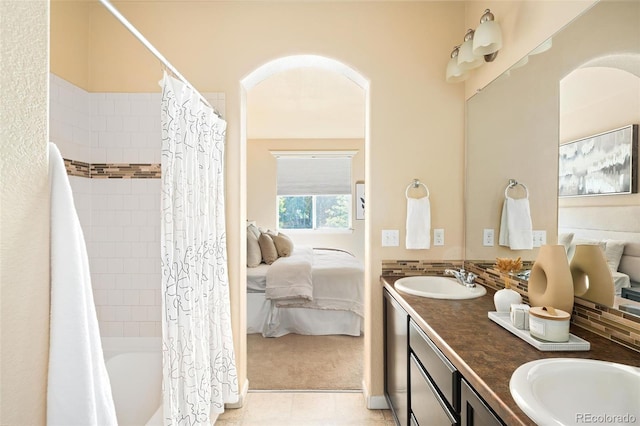 5562 W 72nd Pl, Westminster, CO 80003 - ensuite bathroom featuring double vanity, shower / bath combo, and tile patterned flooring