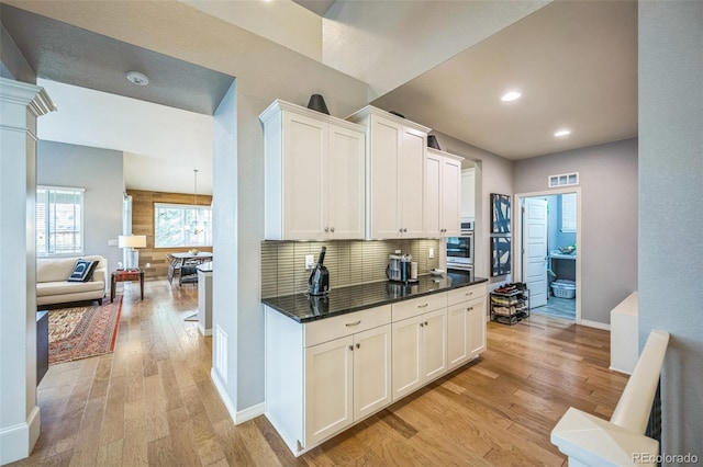 1261 W 170th Ave, Broomfield, CO 80023 - kitchen with light wood finished floors, decorative backsplash, white cabinetry, and recessed lighting