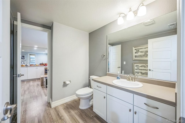 1261 W 170th Ave, Broomfield, CO 80023 - bathroom featuring wood finished floors, vanity, and a textured ceiling