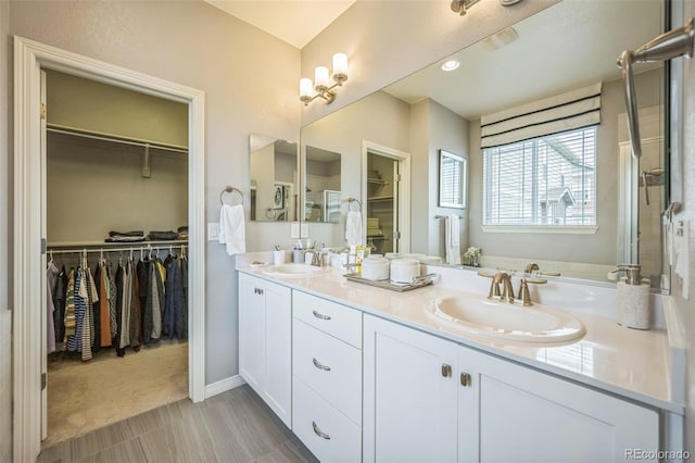 1261 W 170th Ave, Broomfield, CO 80023 - bathroom featuring double vanity and a walk in closet