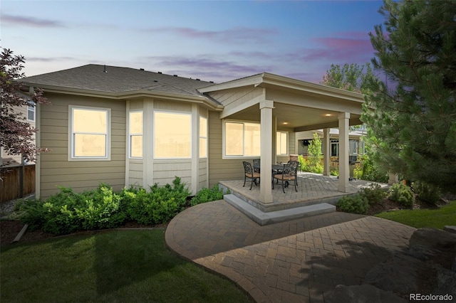 1261 W 170th Ave, Broomfield, CO 80023 - back of property at dusk with a patio and roof with shingles