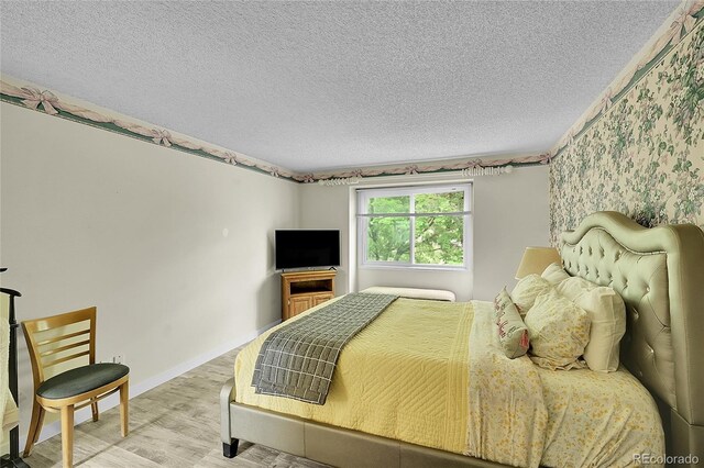 2840 S Kenton Ct, Aurora, CO 80014 - bedroom with a textured ceiling, wood finished floors, and baseboards
